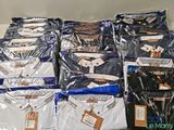 a lot of shirts that are wrapped up on a shelf