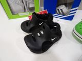 two pairs of black and green shoes on a table