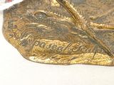 a gold leaf with a string tied to it
