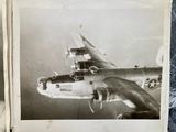 an old photo of a plane flying in the sky