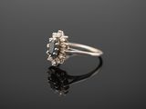 a white gold ring with a blue sapphire and diamonds