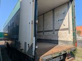 a truck that is parked in a lot with a person taking a picture