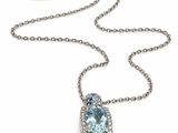a close up of a necklace on a white background with a chain