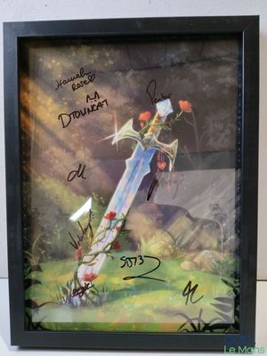 photo encadrée représentant une épée ornée de fleurs, sur laquelle est inscrit un message