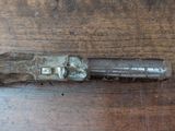 a small metal object on a wooden table