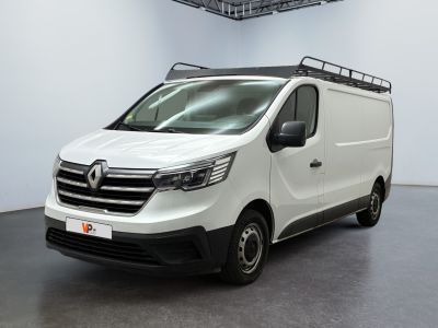 the white van is parked in a large room with a black floor