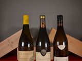 three bottles of wine sitting on a table next to a wooden box