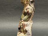 an old statue of a woman holding a baby in her arms