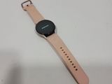 a close up of a smart watch on a white surface