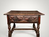 an old wooden table with a drawer on top of it