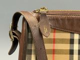a brown and tan plaid purse with a brown strap