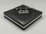 a pen sitting on top of a box on a table