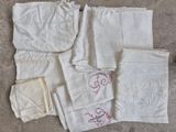 a lot of white linens with different designs on them
