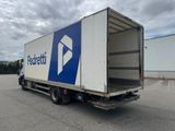 a white truck with a blue and white logo parked in a parking lot