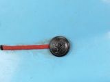 an image of a close up of a small button on a piece of metal