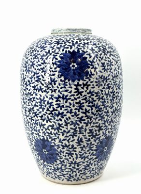 a blue and white vase sitting on a white surface