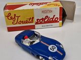 a toy car that is sitting next to a box of cigarettes