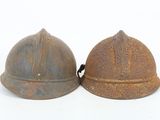 two helmets that are sitting next to each other on a white surface