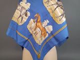 an image of a blue scarf with horses on it on a mannequin head