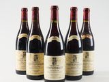 six bottles of wine are lined up on a white surface