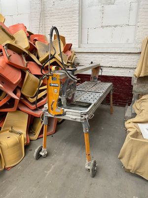 a pile of chairs and a table in a room