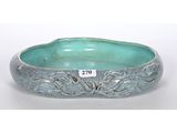 a close up of a bowl on a white surface with a price tag