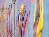 a lot of paint on the side of a colorful wall