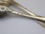 two spoons and a spoon rest on a table