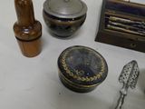 a table with various items on it including spoons, a box, and other items