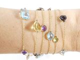 a woman ' s arm with a bunch of bracelets on it
