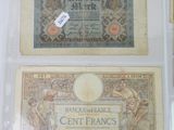 several old french bank notes are on display in a glass case