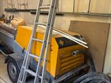 an image of a room with a ladder and a work bench
