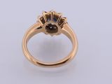 a close up of a gold ring with a black diamond