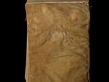 an old book sitting on top of a black surface
