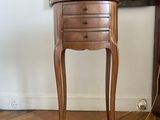 a small table with a lamp on it in a room