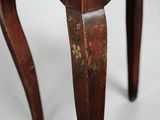 a close up of a wooden table with a floral design on it