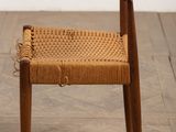 an image of a wooden chair with a woven seat on a wooden floor