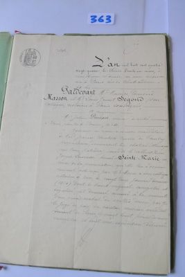 an old document with writing on it sitting on a table