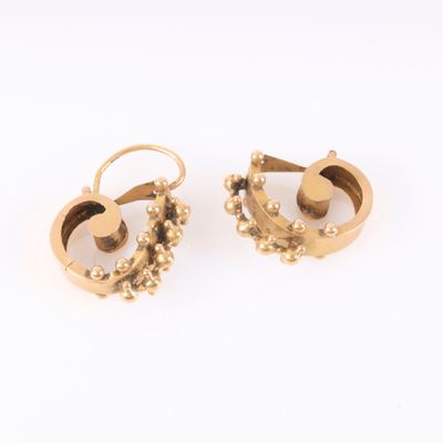 pair of gold earrings with pearls on each side