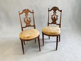 pair of antique chairs with upholstered seats in the shape of a lion and a bird
