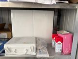 a metal shelf with boxes and other items on top of it