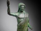 an image of a statue of a woman holding her hand up