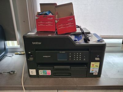 a printer sitting on top of a counter next to a window