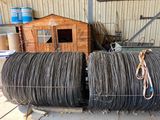 several rolls of steel wire are stacked on top of each other in front of a building