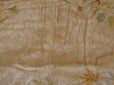 a picture of a bed with a floral design on it