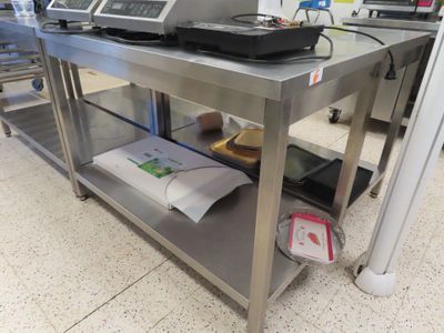 a metal table with a laptop on top of it