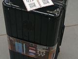 a piece of luggage sitting on the ground with a tag attached to it