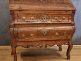 an old wooden chest of drawers on a wooden floor