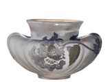 a vase with a flower design on it sitting on a table