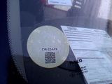 a sticker on the windshield of a car with a qr code on it